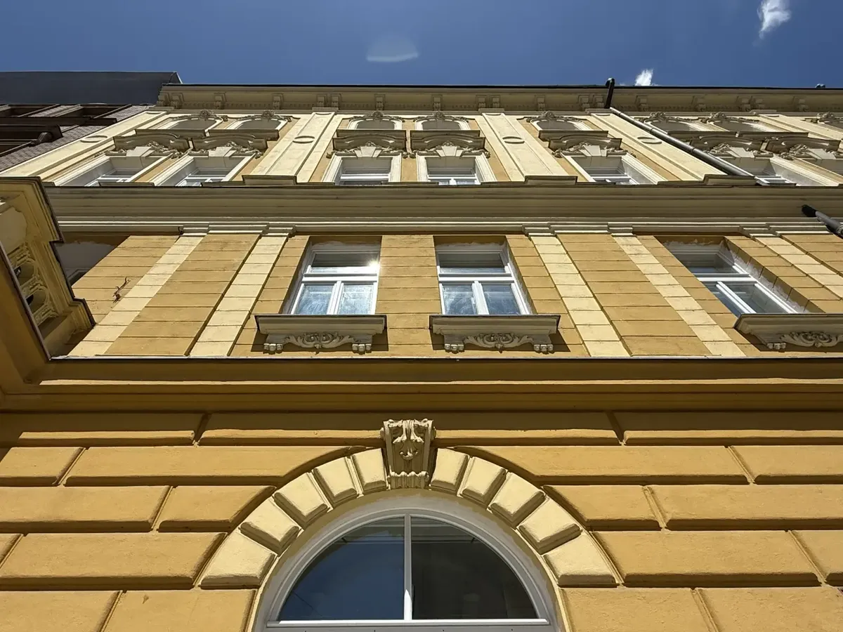 Špaletová okna na žluté historické fasádě